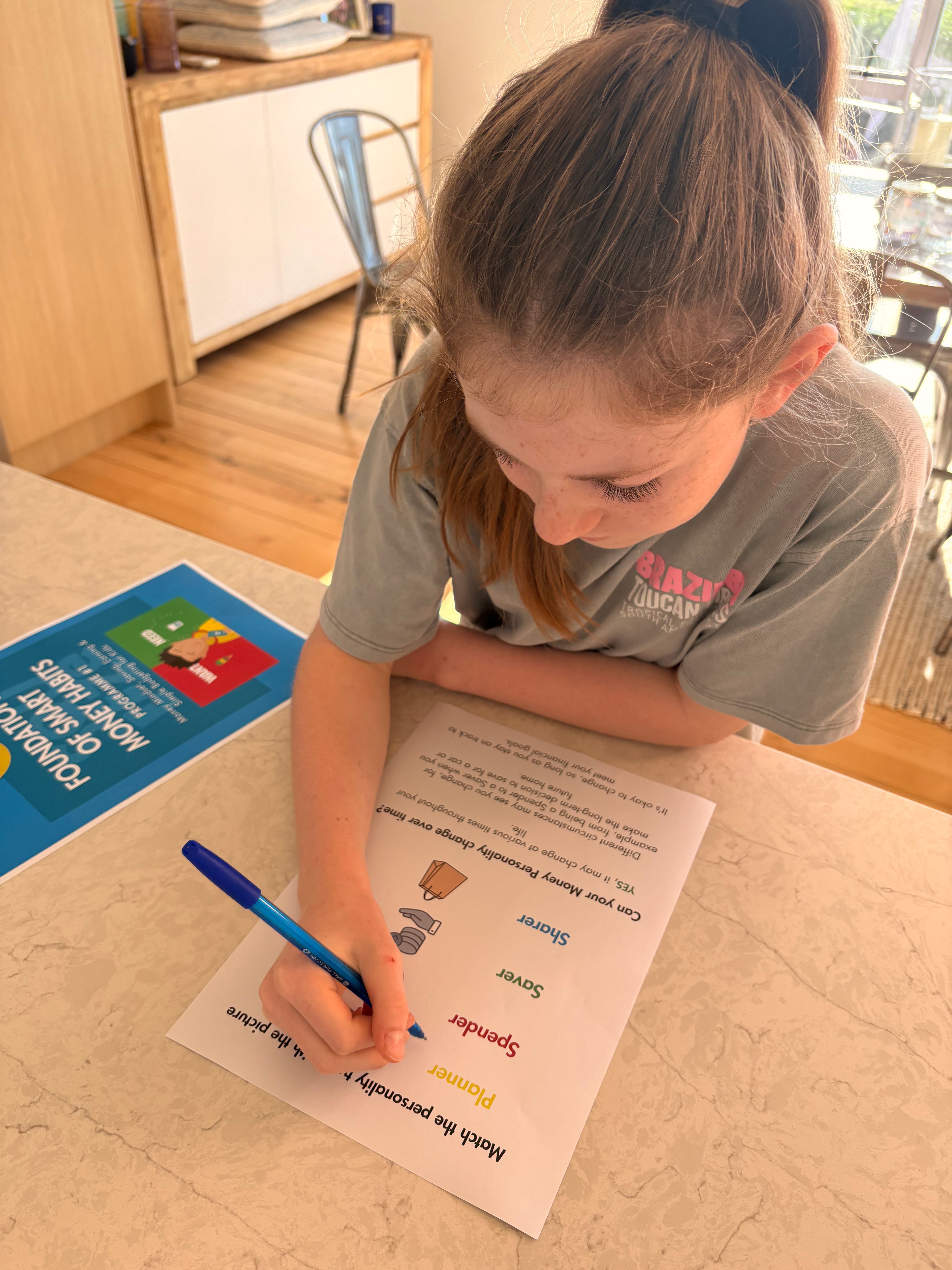 Eden completing a fun activity from Programme 1 Foundations of Smart Money, Financial Literacy for Kids That Builds Money Confidence for Life